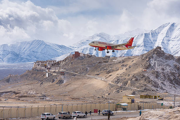 Leh, India - February 16, 2014: Air India plane landing passing monastery in Ladakh on February 16, 2014 at Leh, India